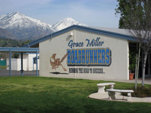 picture of side of school buidling with school's road runner mural